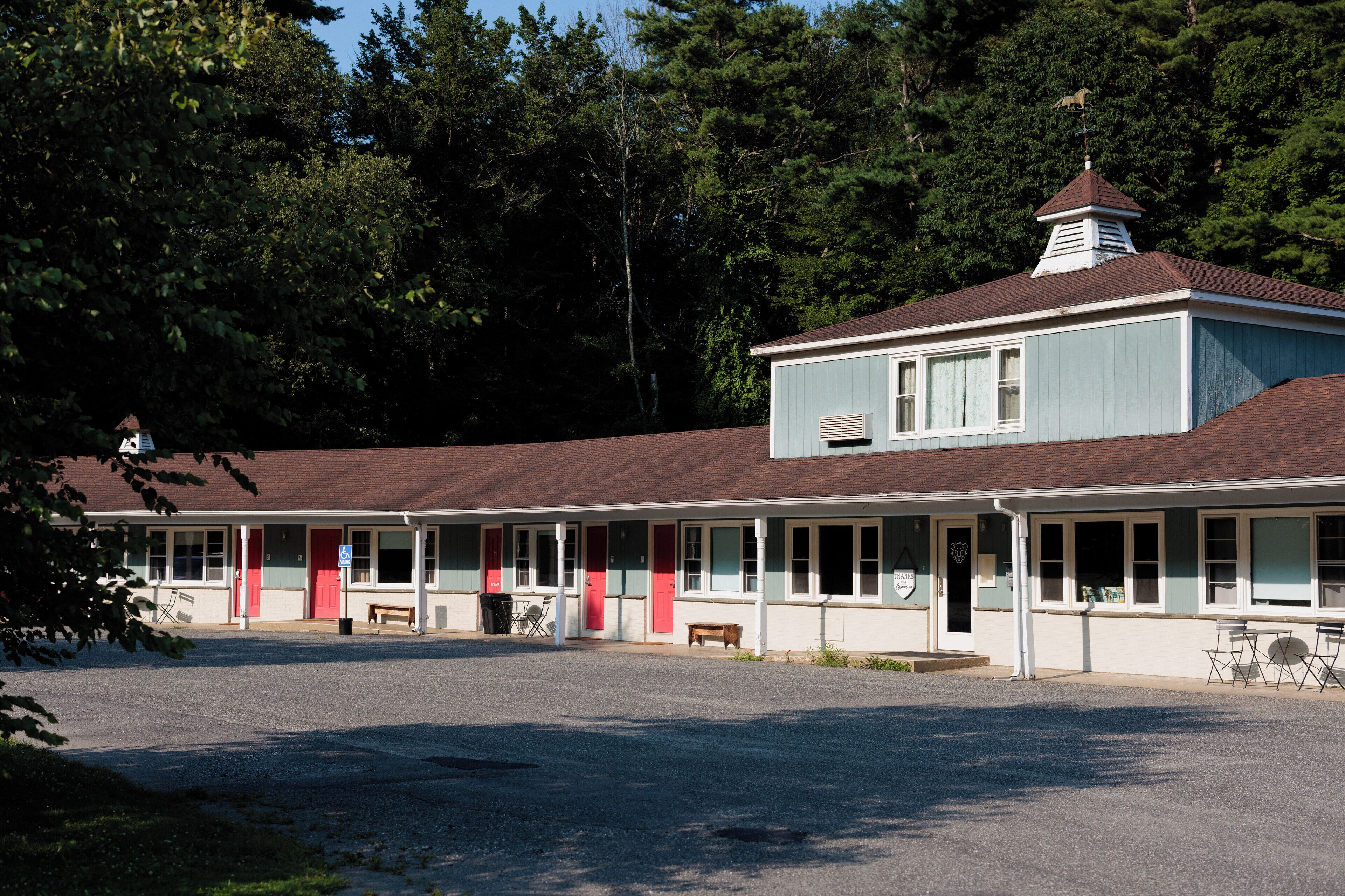 A motel with a central building and a smaller attached structure.
