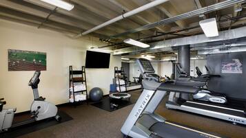 A gym with treadmills, an elliptical, and a stationary bike.