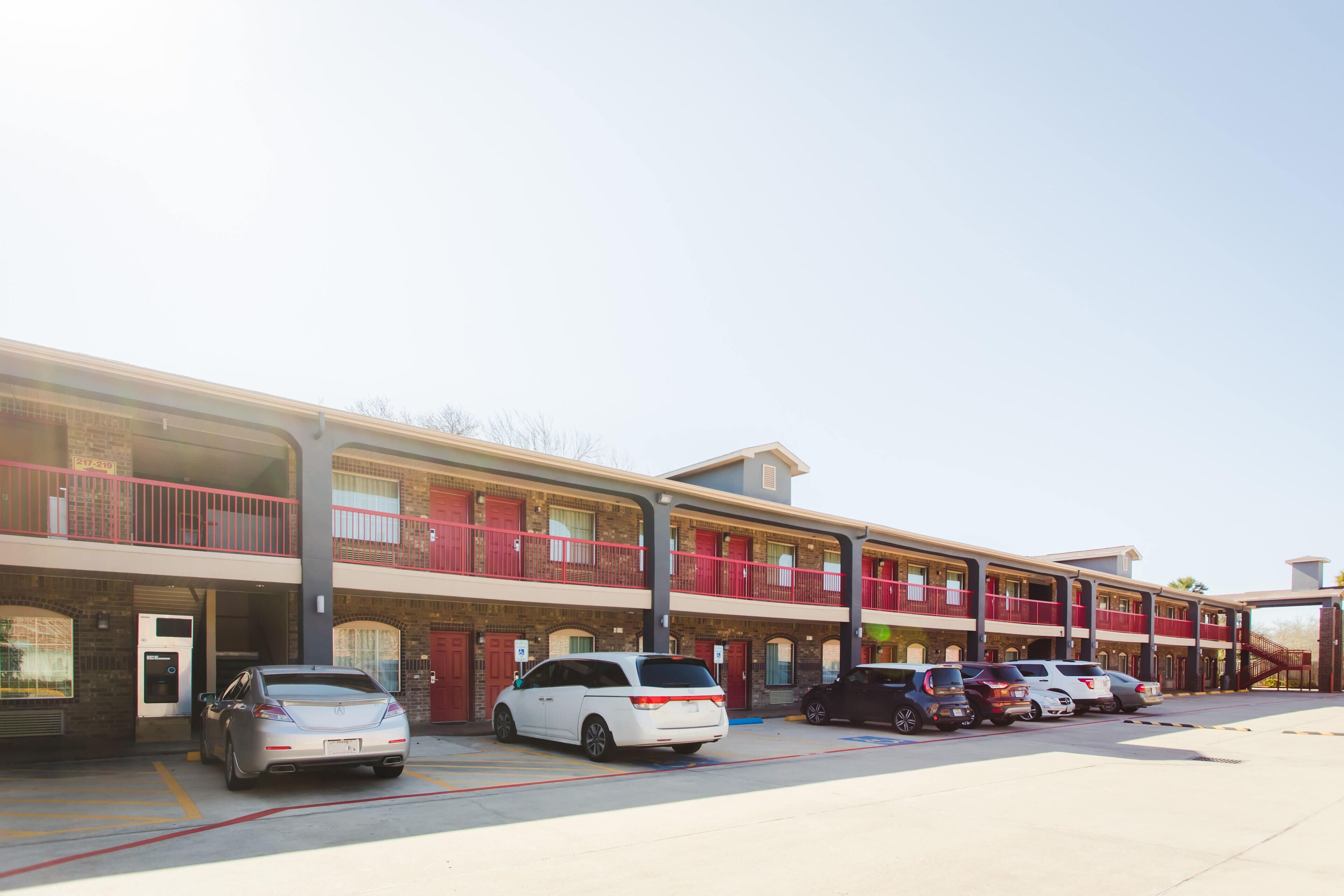 A multi-story hotel with a parking lot.