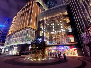 A modern building with a glass facade, large windows, and a prominent entrance area. - The Mulian Hotel Guangzhou Zhujiang New Town (Guangzhou)
