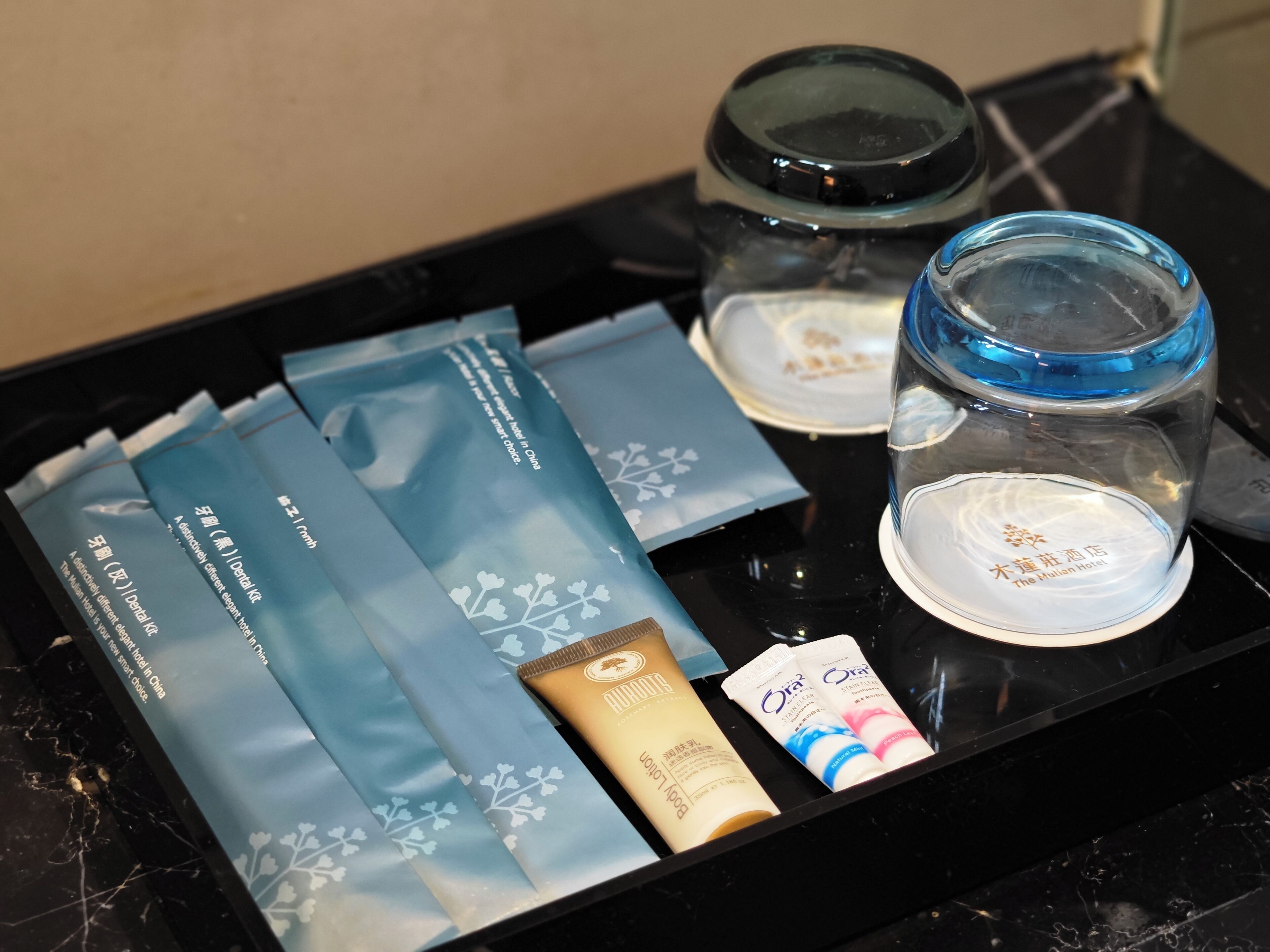 A tray with dental care items, including a toothbrush, toothpaste, and dental floss.
