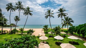 A tropical resort with a beach view, palm trees, and outdoor seating areas. - Shinagawa Beach (Balapitiya)