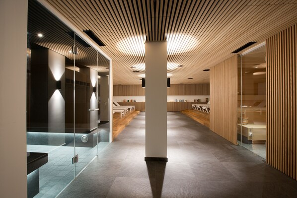 A modern interior with a long corridor, wooden panel walls, and a glass partition on the left.