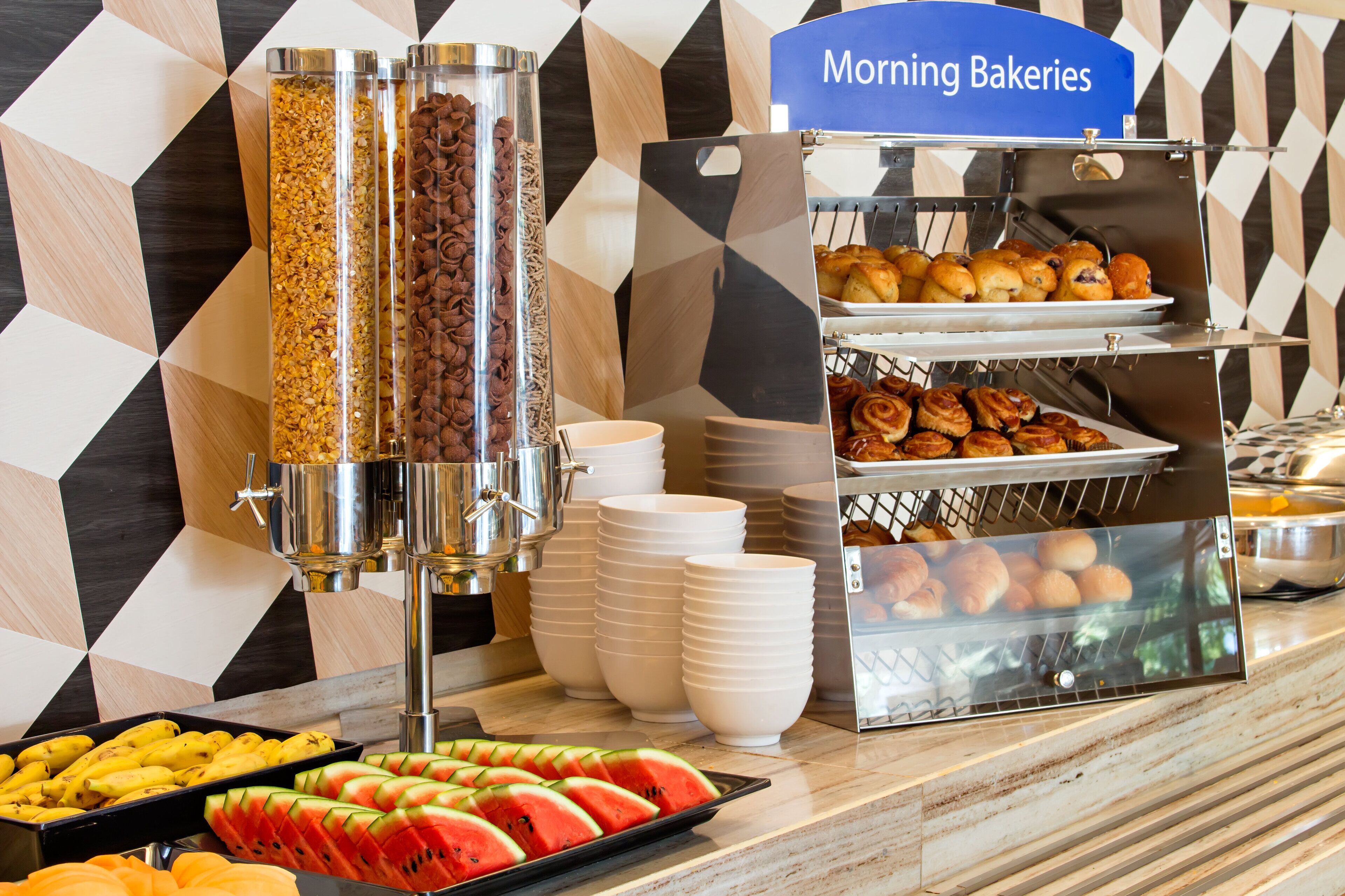 A breakfast buffet with various food items and a coffee station.