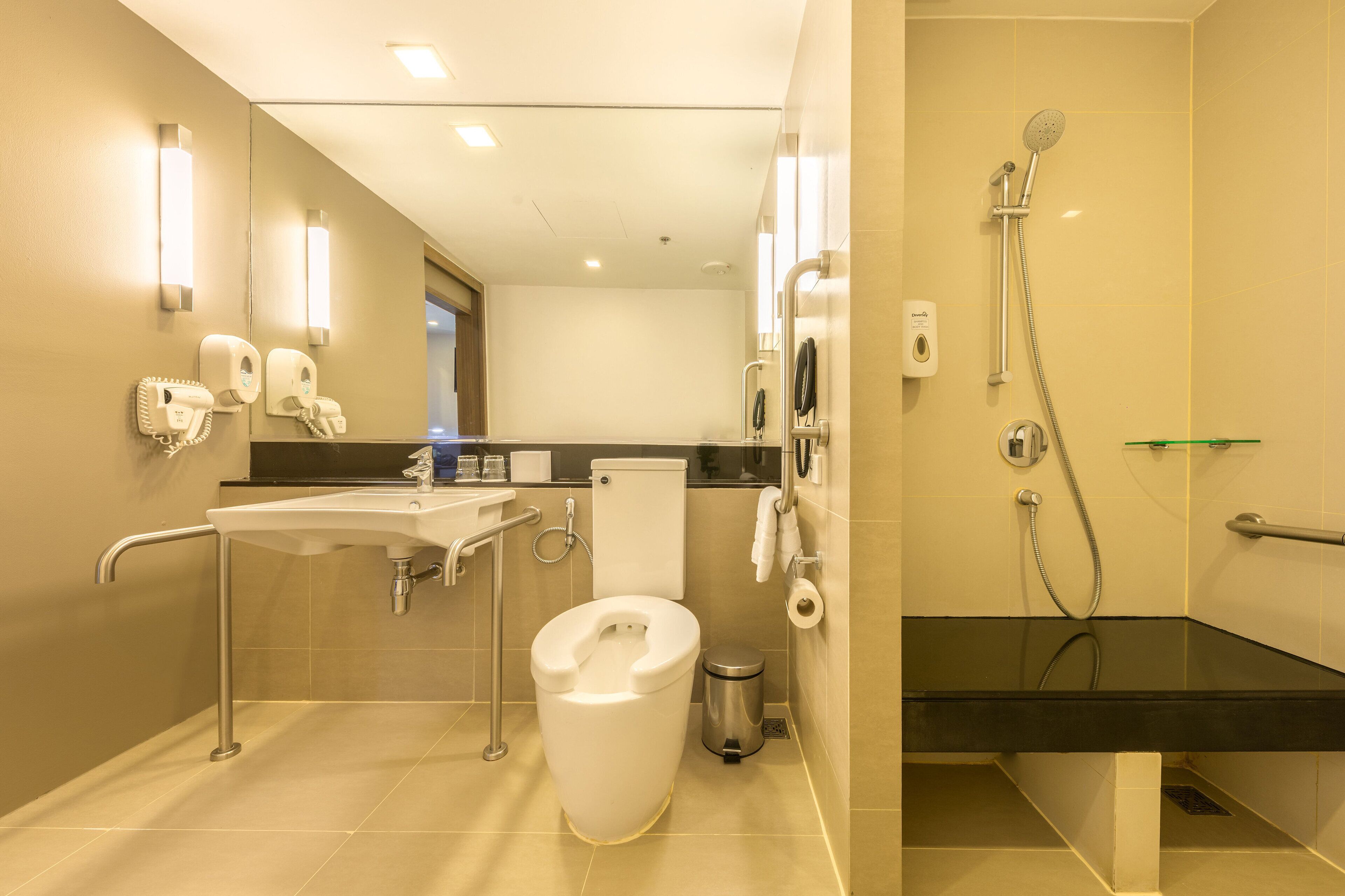 A modern bathroom with a toilet, sink, and shower.