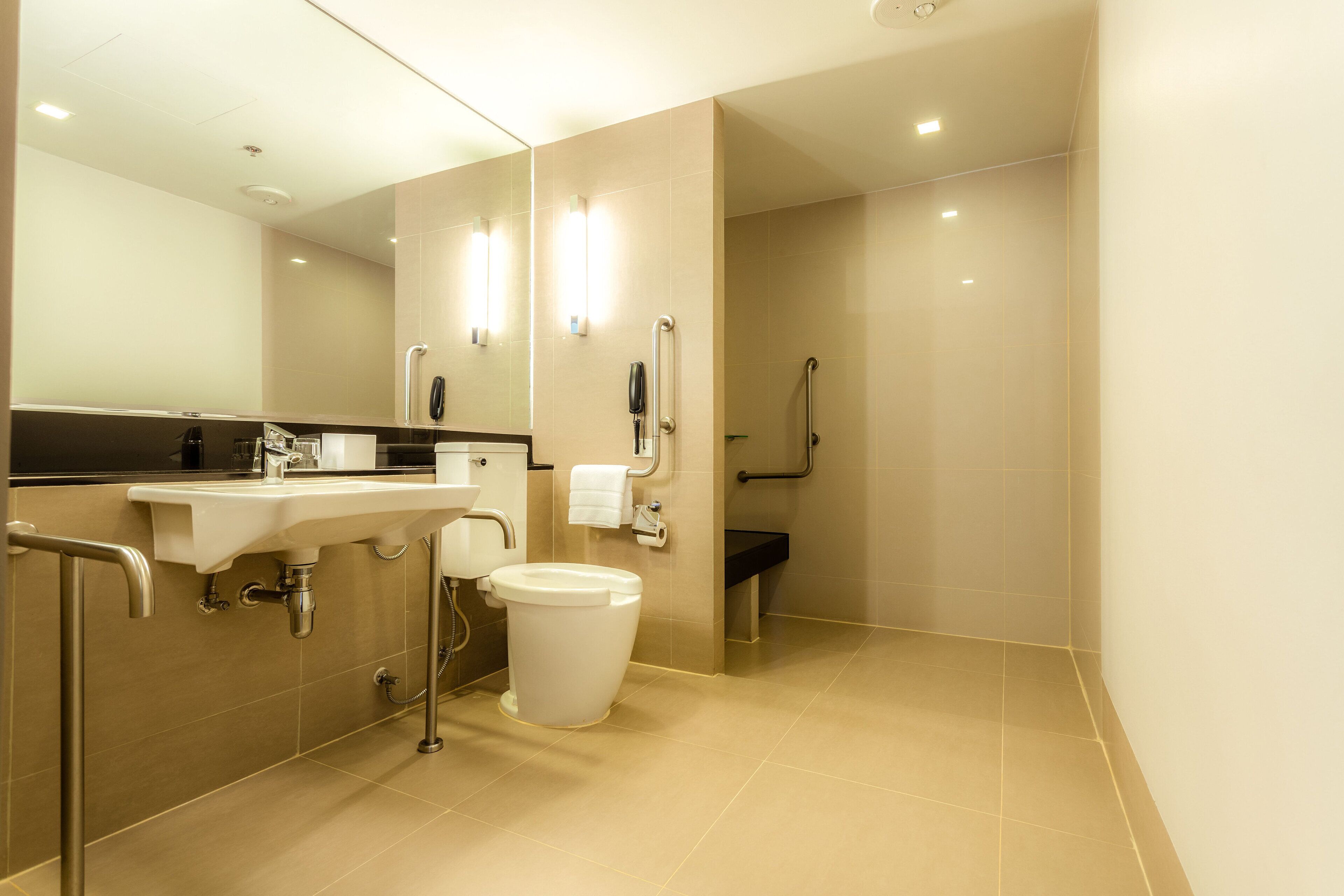A modern bathroom with a sink, toilet, and shower.