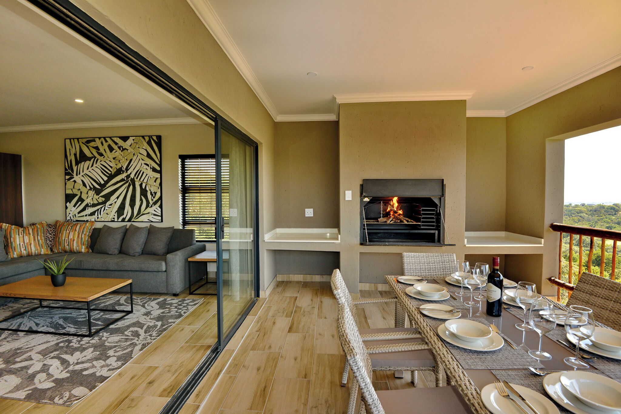 A modern living room with a sofa, coffee table, and fireplace.