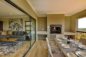 A modern living room with a sofa, coffee table, and fireplace. - Seasons Golf, Leisure & Spa (Hartbeespoort/ Brits)