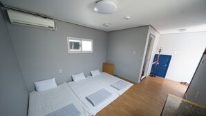 A room with a large bed, a window, and a door. - Beewon Guest House - Hostel (Seoul)