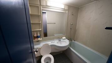 A bathroom with a toilet, sink, and bathtub.