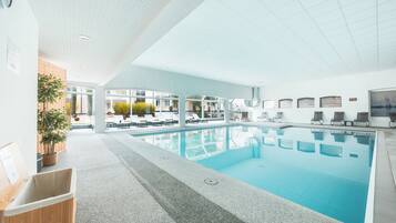 Indoor pool, open 7:00 AM to 11:00 PM, pool loungers
