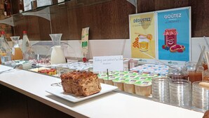 A breakfast buffet with various food items and beverages, including pastries, juices, and dairy products. - Green Hôtels Poitiers (Poitiers)