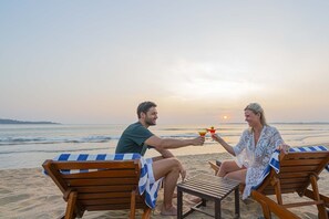 On the beach, white sand, sun-loungers, beach umbrellas