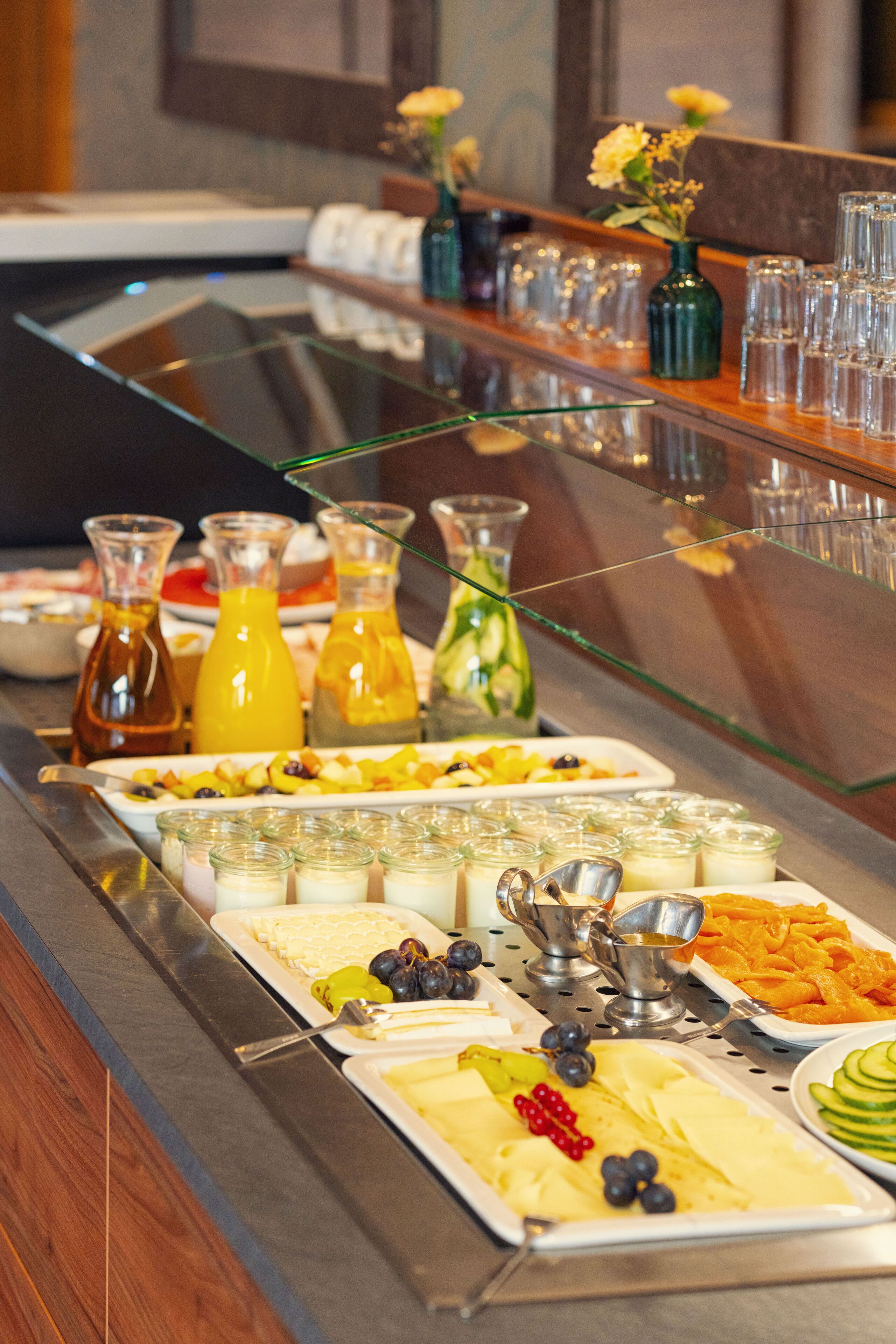 A buffet with various food items and beverages.