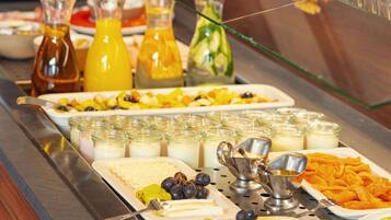 A buffet with various food items and beverages.