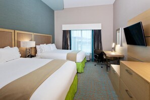 A hotel room with two beds, a desk, a chair, a television, and a window with curtains. - Holiday Inn Express Hotel & Suites Warner Robins North West by IHG (Warner Robins)