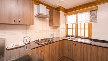 Suite, 1 Bedroom | Private kitchen | Coffee/tea maker, electric kettle