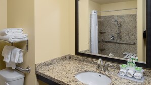 A bathroom with a sink, mirror, and towel rack. - Holiday Inn Express Klamath - Redwood Ntl Pk Area by IHG (Klamath)