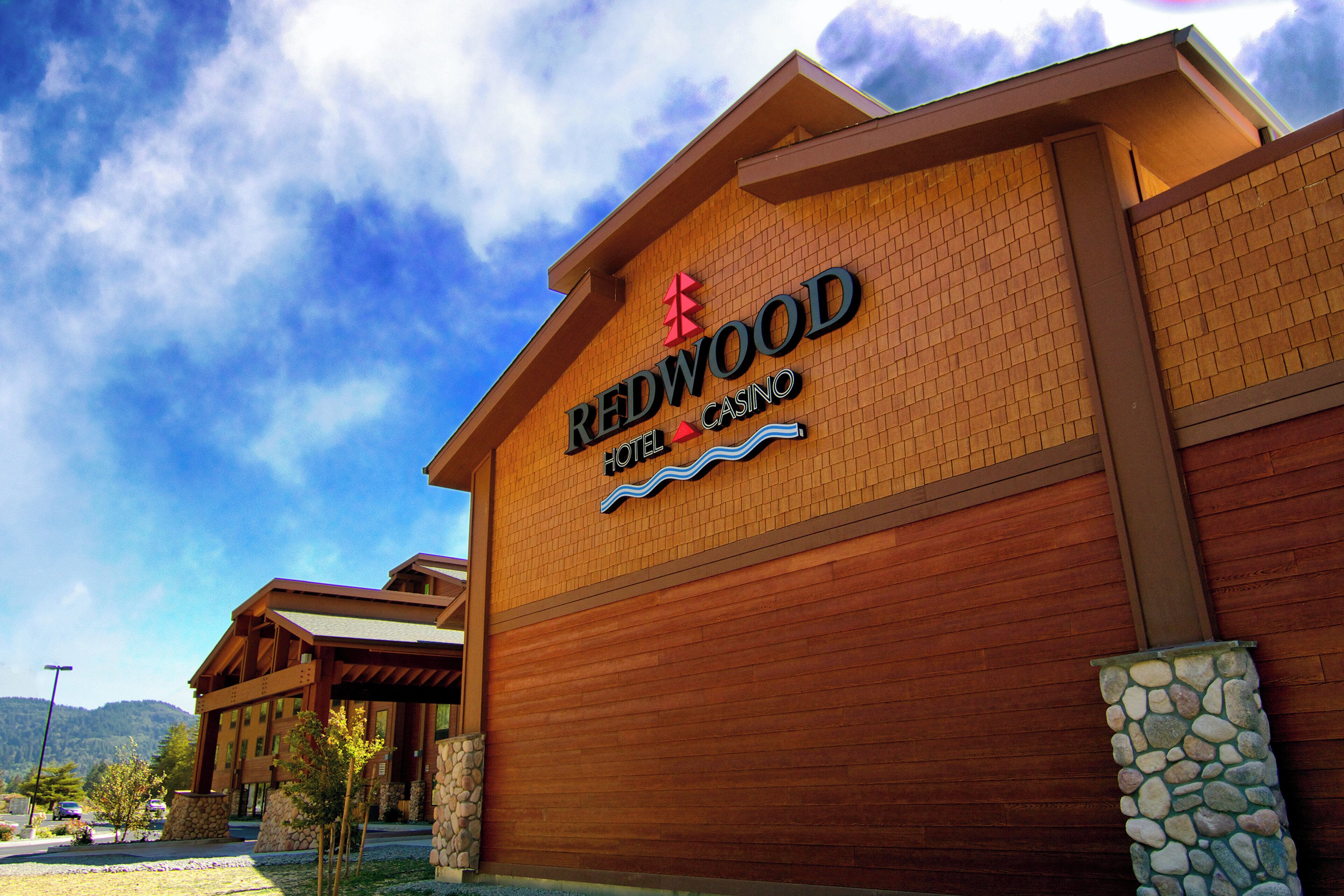 A Redwood Casino Hotel with a prominent sign, brick facade, and stone accents.