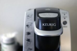 A coffee maker with the brand name KEURIG. - Holiday Inn Express Klamath - Redwood Ntl Pk Area by IHG (Klamath)