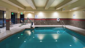 A swimming pool with a lifeguard chair, a pool lift, and a sign indicating a depth of 3 feet 11 inches. - Holiday Inn Express Klamath - Redwood Ntl Pk Area by IHG (Klamath)