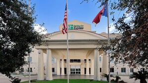 A Holiday Inn Express building with a classical facade, columns, and a central entrance.