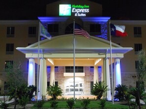 A Holiday Inn Express & Suites hotel entrance with a flag display, a flag of the United States, and a flag of Texas. - Holiday Inn Express Hotel & Suites Houston NW-Brookhollow by IHG (Houston)