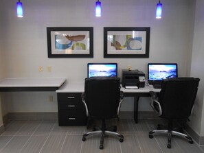 A workspace with two desks, two chairs, two monitors, a printer, and framed artwork on the wall. - Holiday Inn Express Hotel & Suites Houston NW-Brookhollow by IHG (Houston)