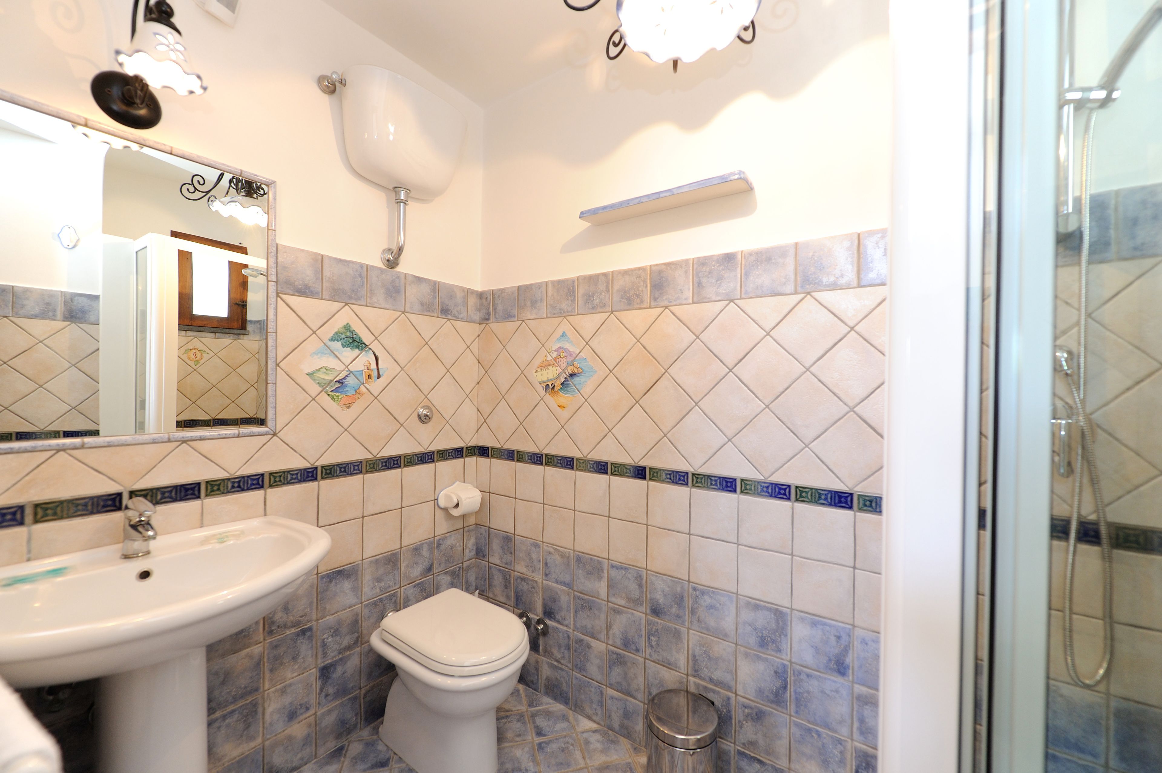 A bathroom with a sink, toilet, and shower.