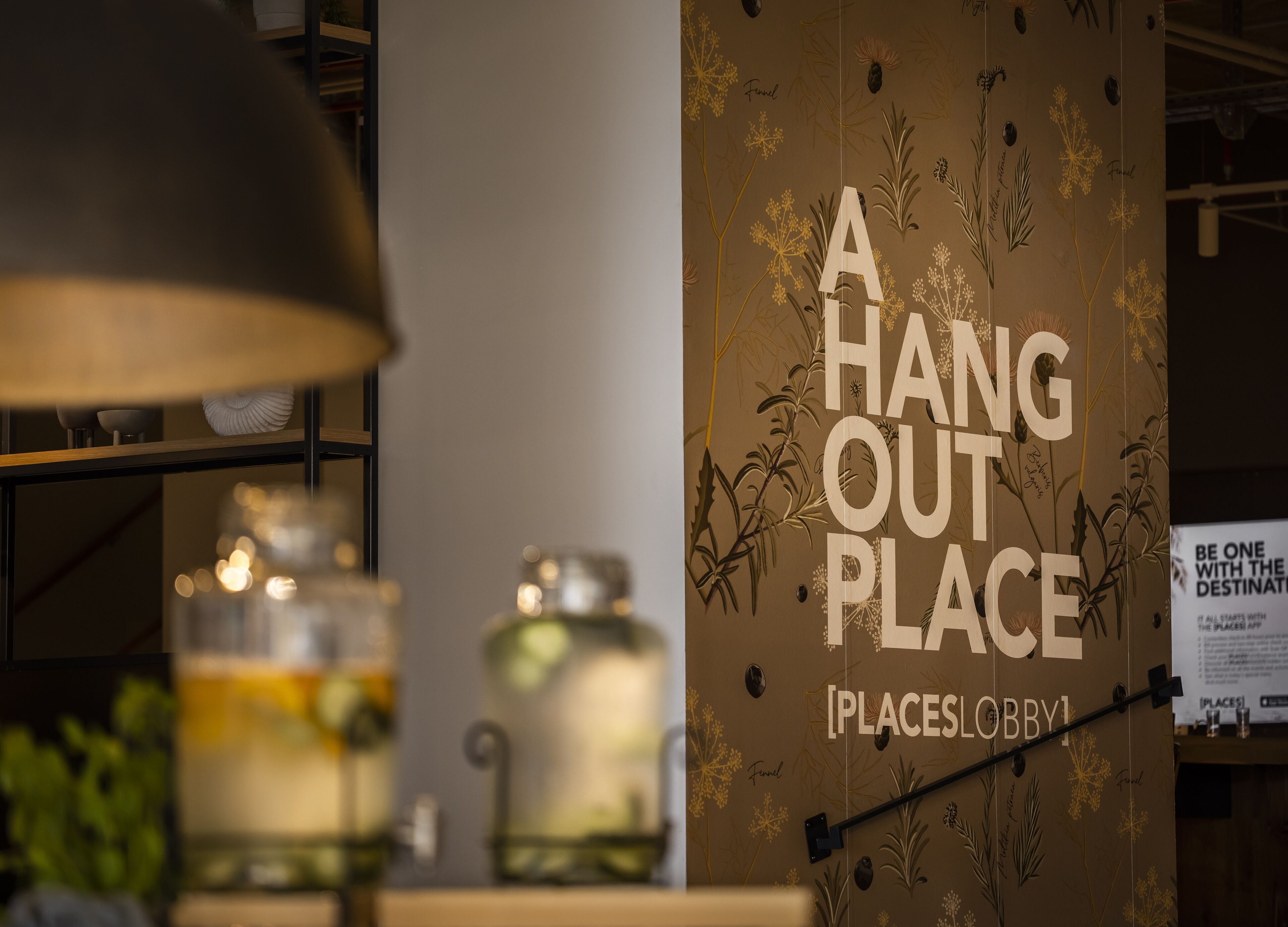A wall with a sign reading "A HANG OUT PLACE" and a signboard for "PLACESLOBBY".