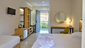 A hotel room with a bed, a desk with a chair, a wardrobe, a mirror, and a television. - Club Zante Plaza (Zakynthos)