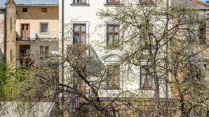 A multi-story building with a balcony, large windows, and a chimney. - Saint Feder (Lviv)