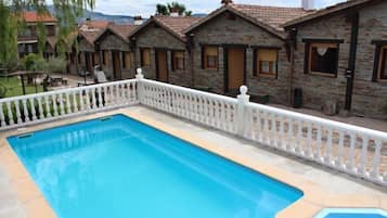 Seasonal outdoor pool, pool umbrellas, pool loungers