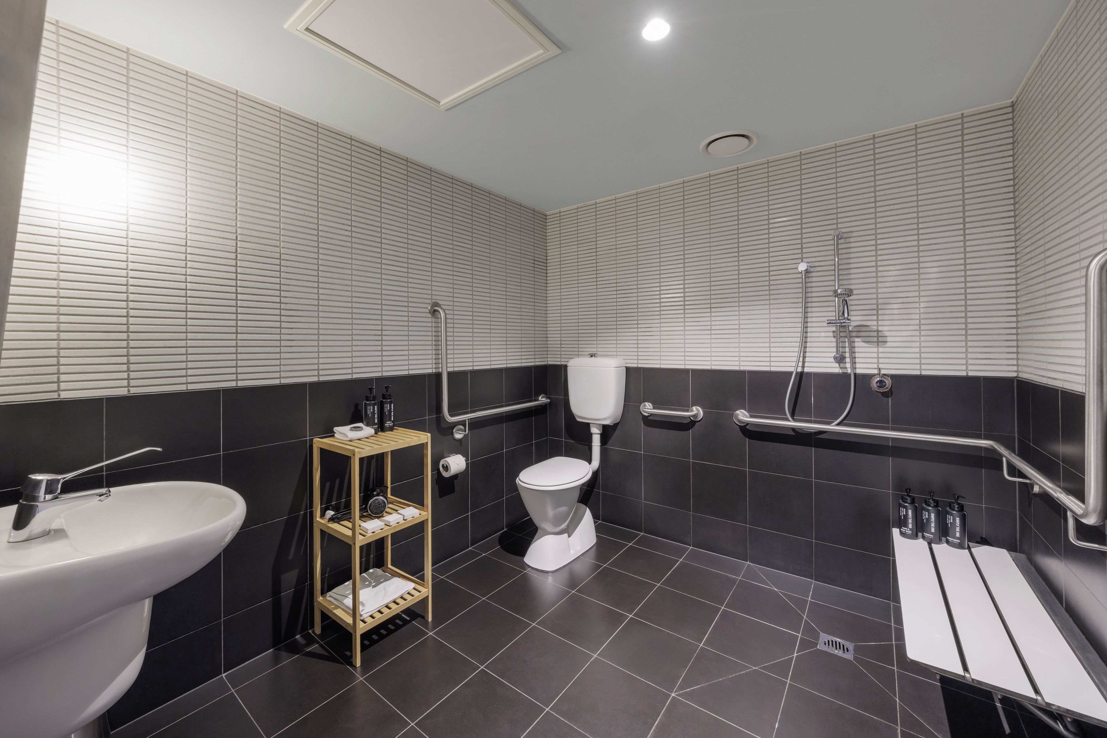 A modern bathroom with a toilet, bidet, and sink.