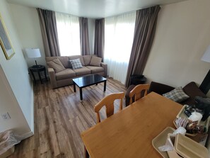 Room, 2 Double Beds | Living area | Flat-screen TV