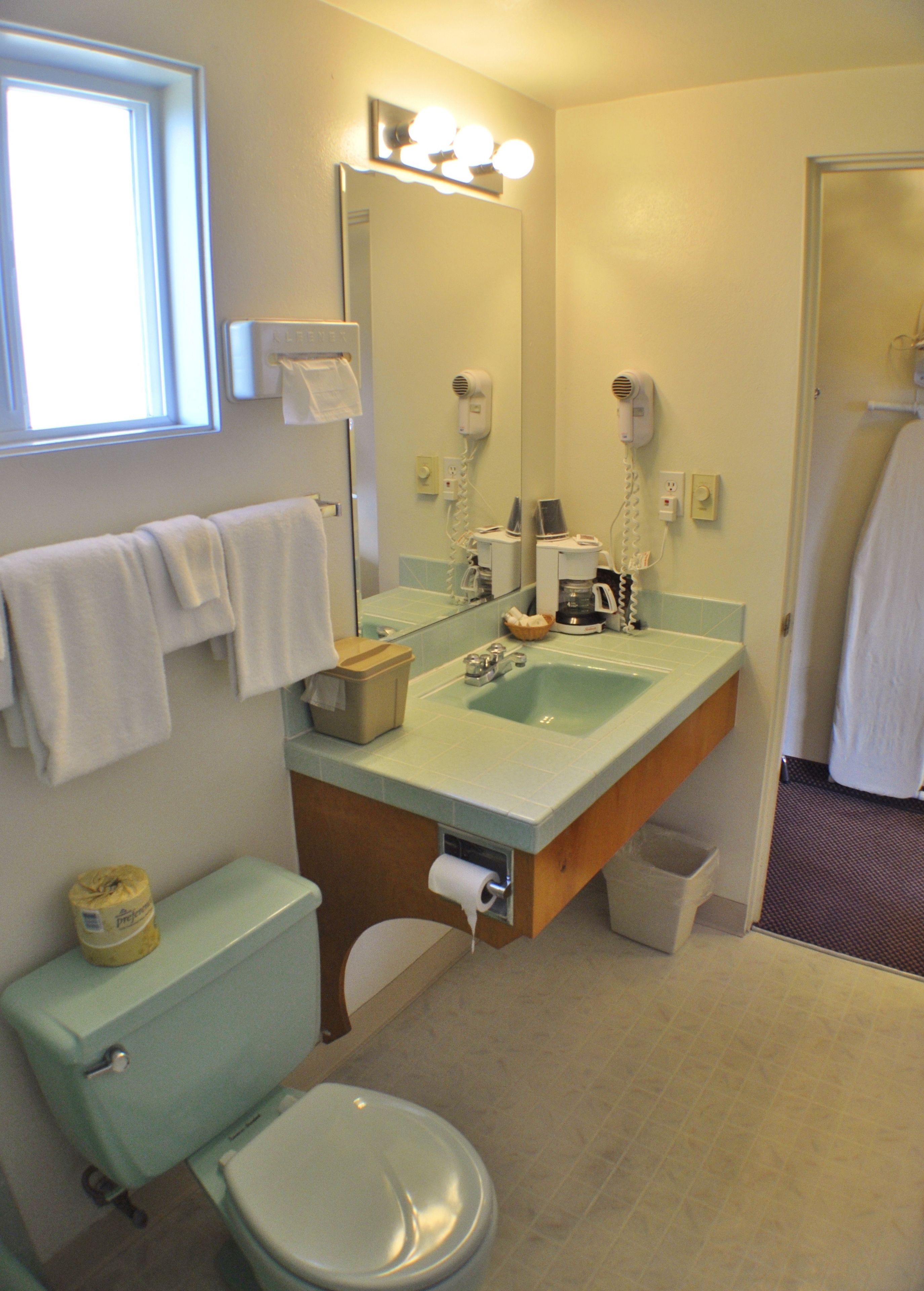 Un baño con inodoro, lavabo y espejo.