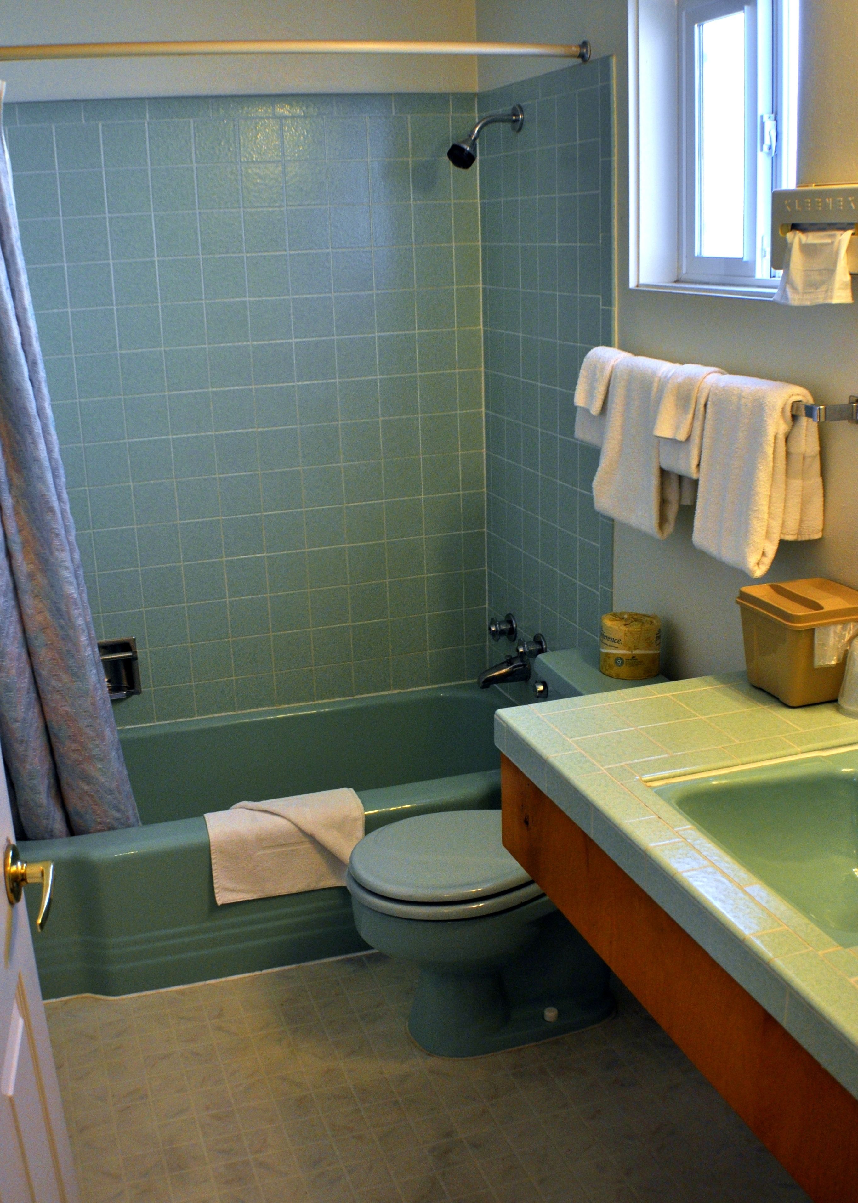 A bathroom with a bathtub, toilet, and sink.