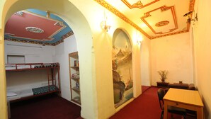A room with bunk beds, a desk, and a bookshelf. - Hotel Himalaya Yoga (Kathmandu)