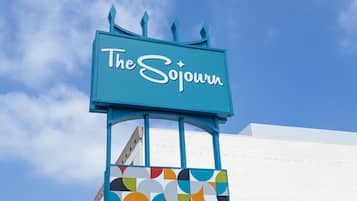 A sign for 'The Sojourn' with a colorful geometric pattern below it.