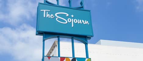 A sign for 'The Sojourn' with a colorful geometric pattern below it.