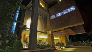 A hotel entrance with a prominent sign reading "Six Seasons." - Six Seasons Hotel (Dhaka)