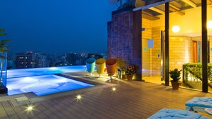 A rooftop pool area with a view of the city at dusk. - Six Seasons Hotel (Dhaka)