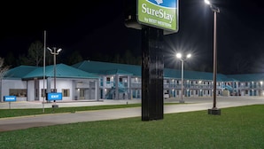 A SureStay by Best Western hotel with a sign indicating an entrance and exit. - SureStay by Best Western Gulfport (Gulfport)