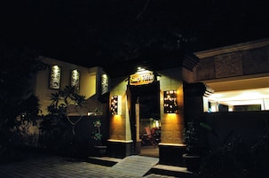 A hotel entrance with a sign reading "Sari Villa."