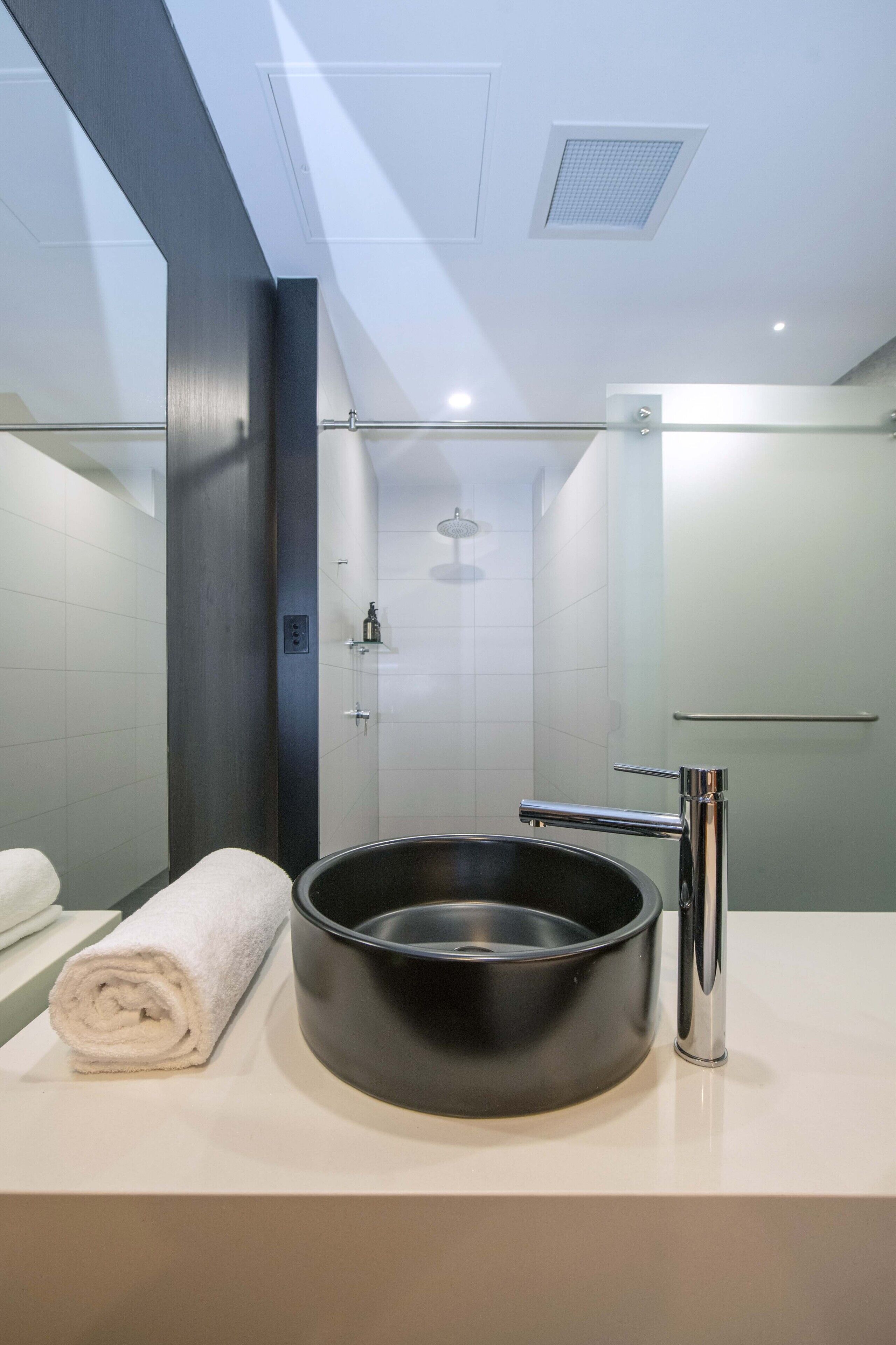 deluxe bridgeview suite | bathroom | shower, free toiletries, hair dryer, towels