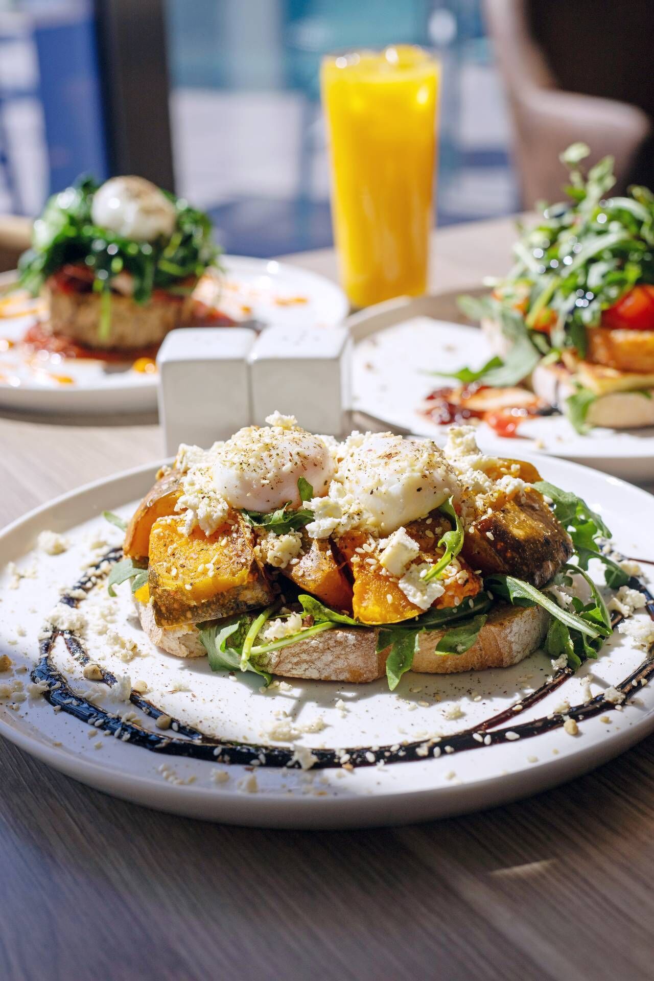 A meal with a poached egg, cheese, and vegetables on a plate.