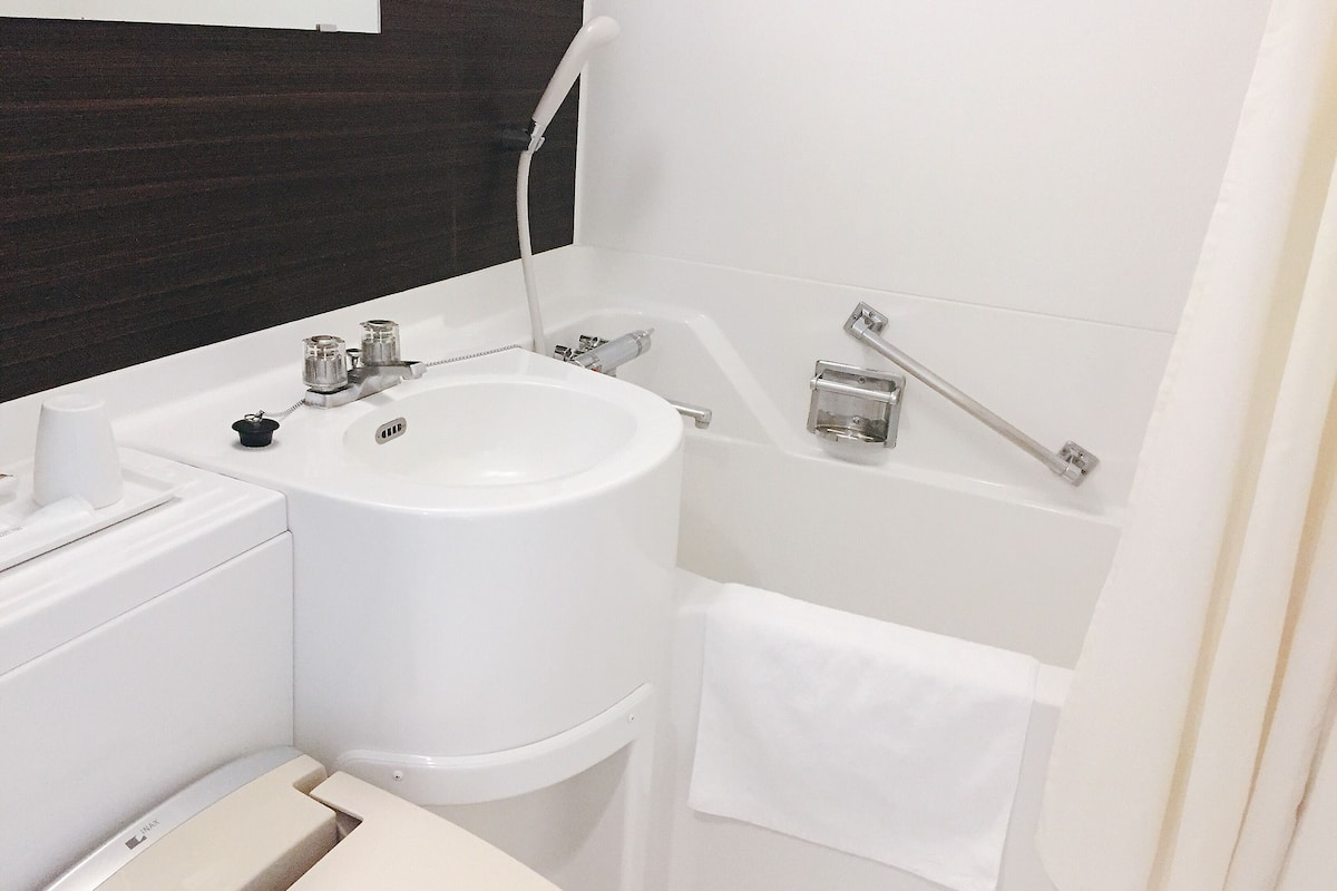 hair dryer, slippers, electronic bidet, towels