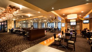 A modern hotel lobby with a reception desk, seating areas, and large windows. - Nightcap at Excelsior Hotel (Thomastown)