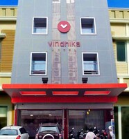 A building with a prominent 'Vindaika' sign, featuring vertical lines and a red logo.