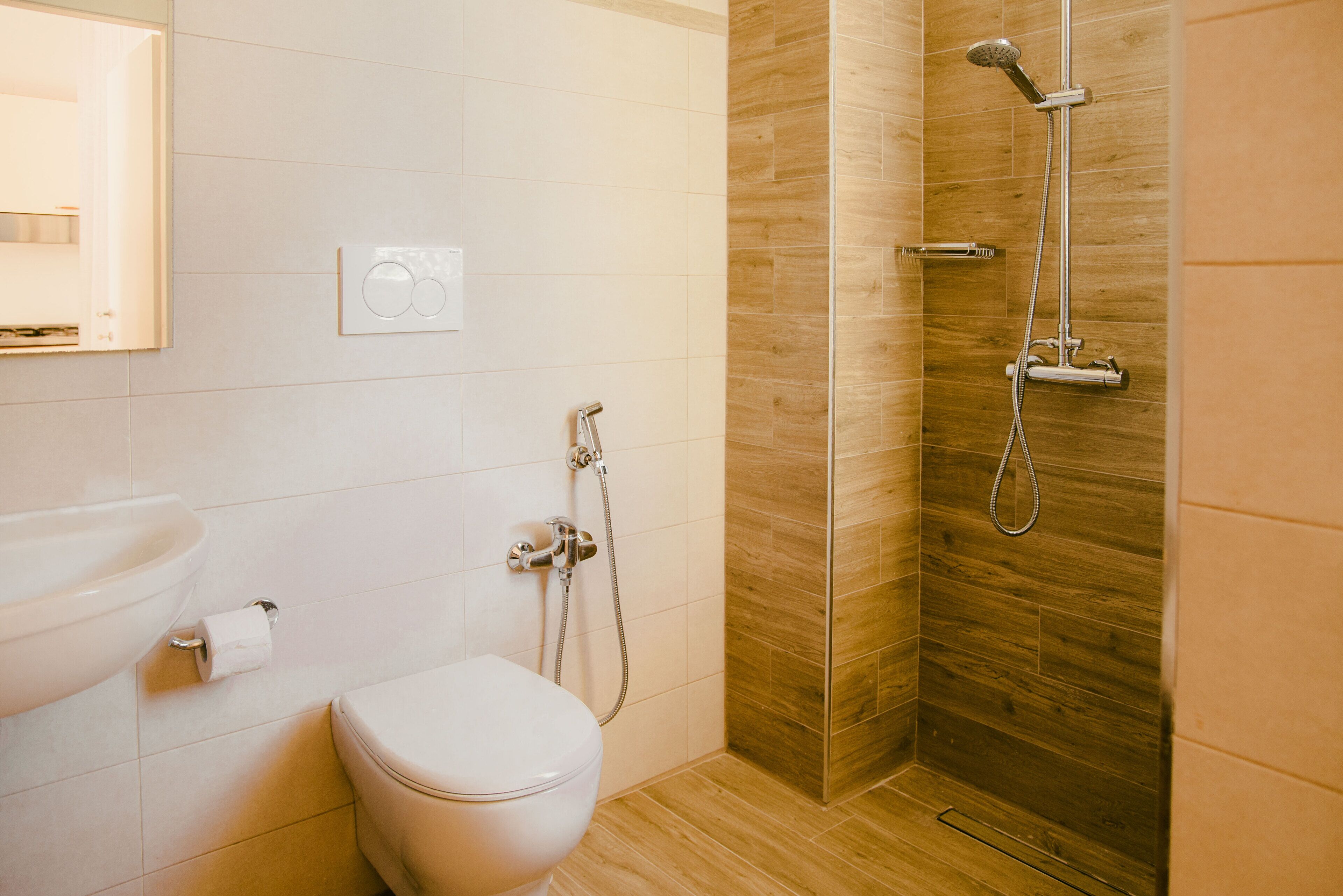 A bathroom with a toilet, sink, and shower.